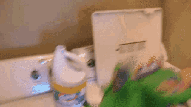 a bottle of clorox is sitting on a counter next to a washing machine
