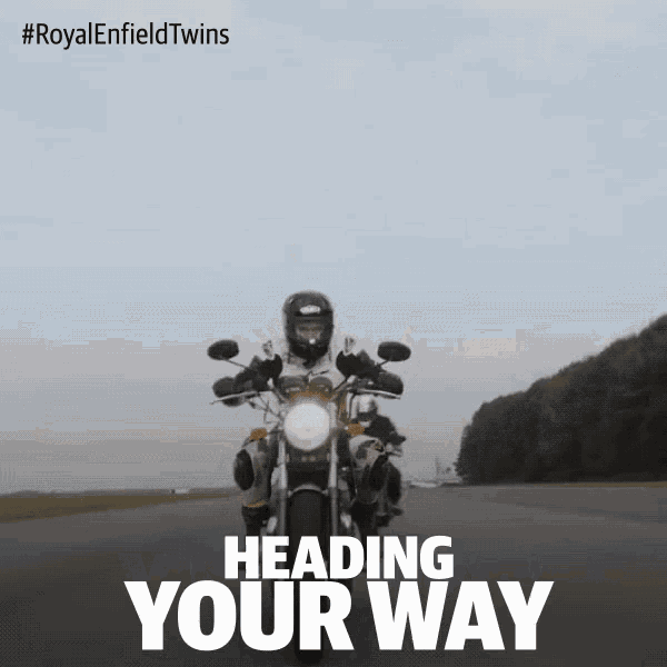 a person riding a motorcycle on a road with the words heading your way