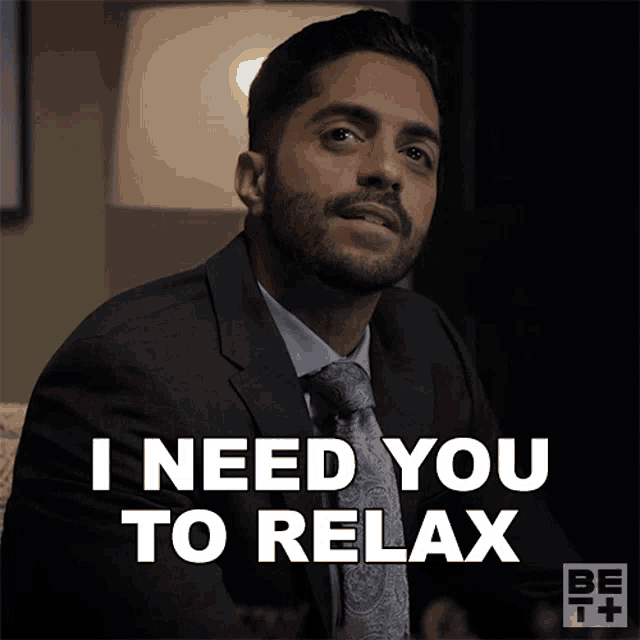 A serious man looks toward the camera beside the caption “I NEED YOU TO RELAX.”