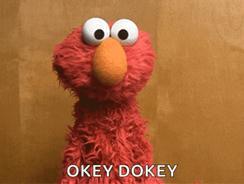 Elmo faces forward with the caption “OKEY DOKEY.”