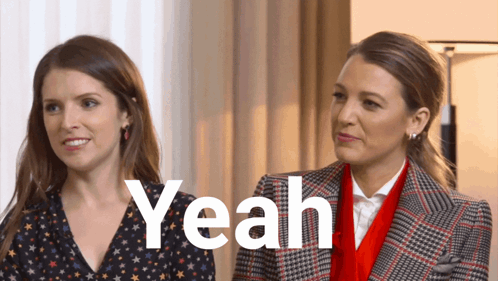 two women are standing next to each other and the word yeah is visible