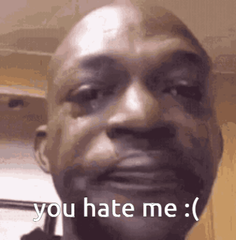 a close up of a man 's face with the words `` you hate me '' on it .