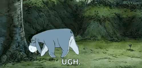 Eeyore hangs his head sadly in a forest clearing with “UGH.” on screen.