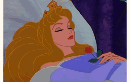 Disney’s Aurora sleeps in bed.