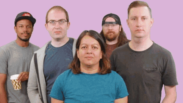 a group of people are posing for a picture and one of them has a hat that says risk on it
