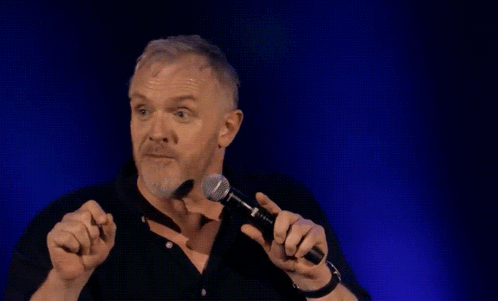 a man holding a microphone with the words " and that is true " behind him