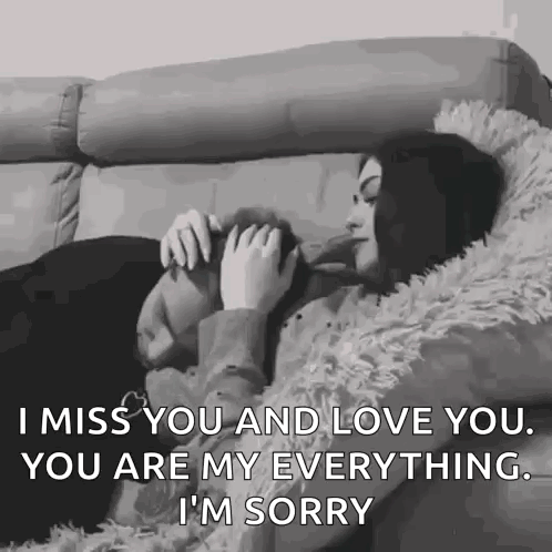 A couple cuddles in bed with the caption “I MISS YOU AND LOVE YOU.”