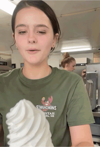 a girl wearing a green shirt that says ' huckings ' on it