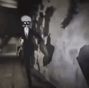 a black and white photo of a person standing in a dark room with smoke coming out of it .