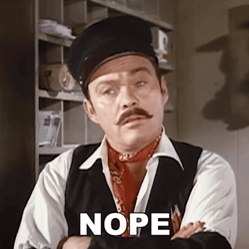a man with a mustache is wearing a hat and vest and has the word nope written on his chest