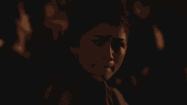 a close up of a woman 's face in the dark