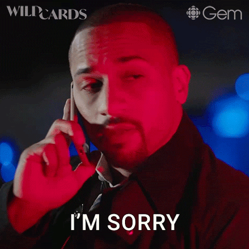 a man talking on a cell phone with the words i 'm sorry on his face