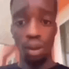 A man looks down with a blank, sad expression in a low-resolution reaction clip.