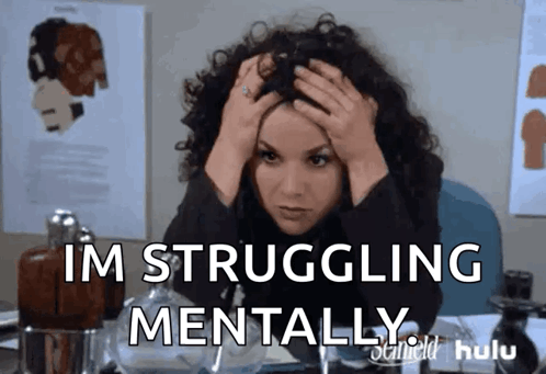 A woman holds her head with both hands, captioned “I’M STRUGGLING MENTALLY.”