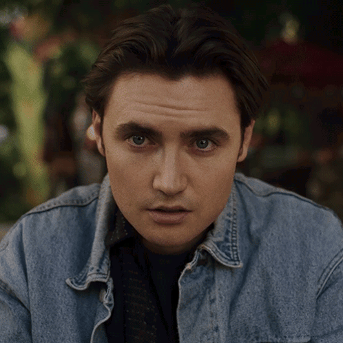 a man wearing a denim jacket has the word no written on his face