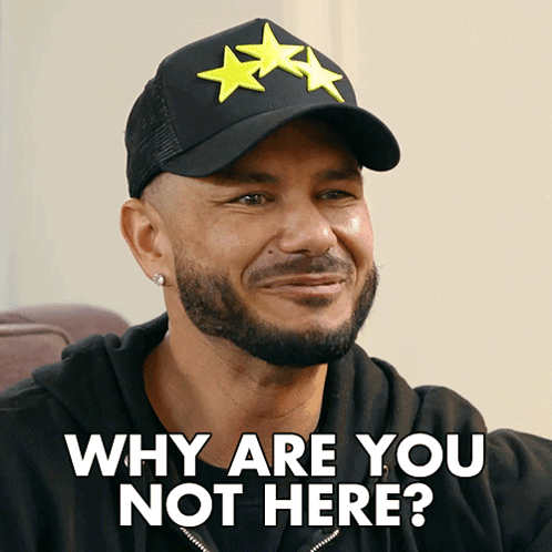 a man wearing a hat that says why are you not here on it