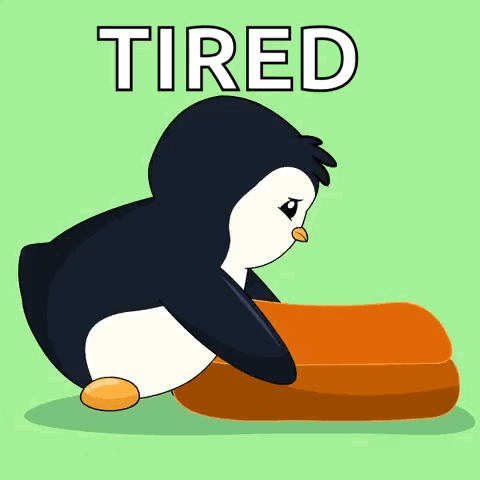 A slumped cartoon penguin lies beside an orange pillow under TIRED text.