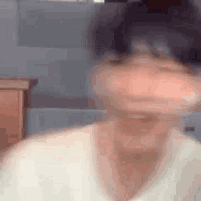 a blurry picture of a person 's face with a blurred background .