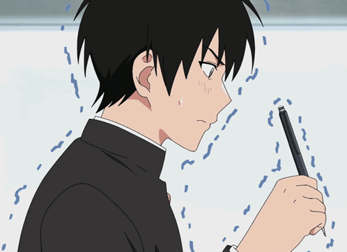 a boy is holding a pen in his hand and looking at it with a surprised look on his face
