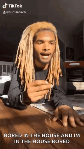 A person speaks to camera in a TikTok clip captioned “BORED IN THE HOUSE AND I'M IN THE HOUSE BORED.”