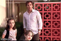 a man and two children are standing in front of a red wall that says imgflip.com