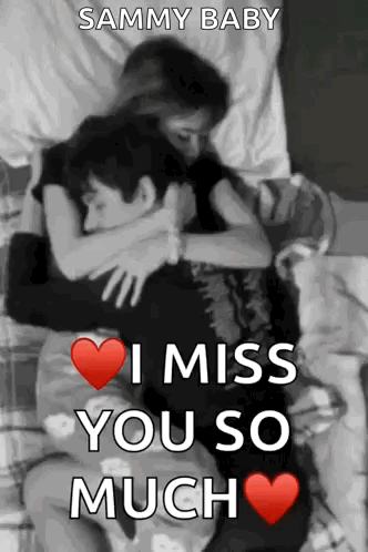 a man and a woman are hugging each other in a bed .