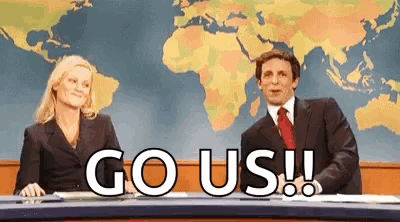News-desk presenters celebrate with large “GO US!!” text.