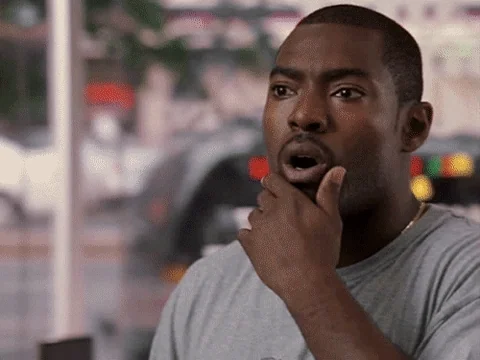 A man pauses with his hand on his chin in a sudden realization.