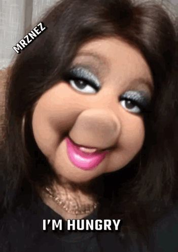 A glam puppet-like character says “I'M HUNGRY.”