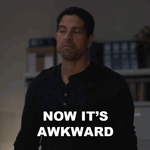 A man in dark clothing stands under the caption “NOW IT'S AWKWARD.”