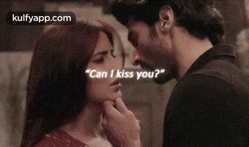 a man is touching a woman 's face and asking her if she can kiss him .