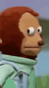 A puppet monkey turns its eyes sideways in an awkward reaction.