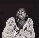 A streamer in black and white covers his mouth in terror.