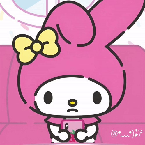 a pink bunny with a yellow bow is sitting on a couch