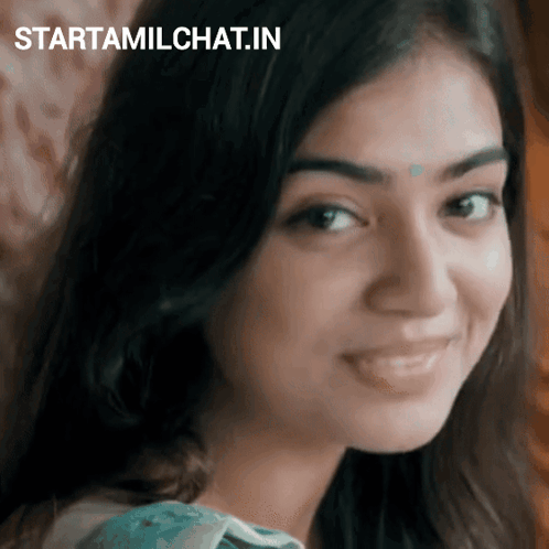 Nazriya looks sideways with a shy, thoughtful smile.