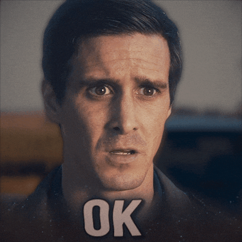 a close up of a man 's face with the word ok on his face
