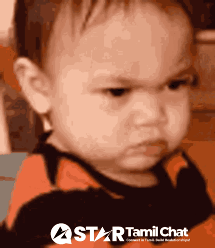 A baby frowns with an intensely angry expression.