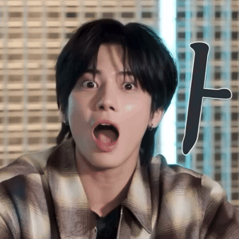 a young man in a plaid shirt is making a funny face