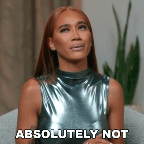 a woman in a metallic top is sitting on a couch and says absolutely not .