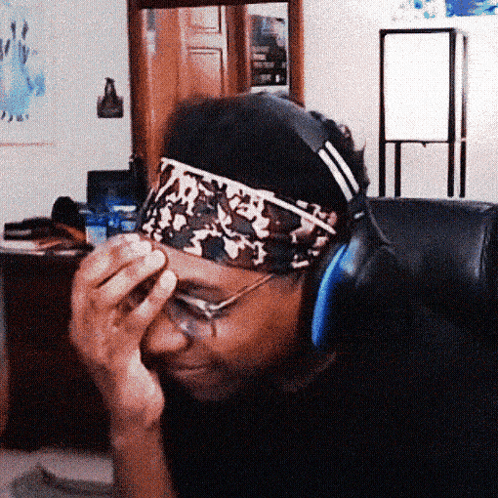 a man wearing headphones and a headband with a camo pattern