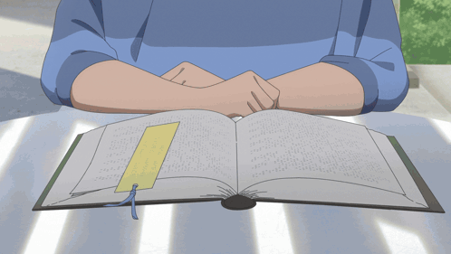 a person sits at a table reading a book