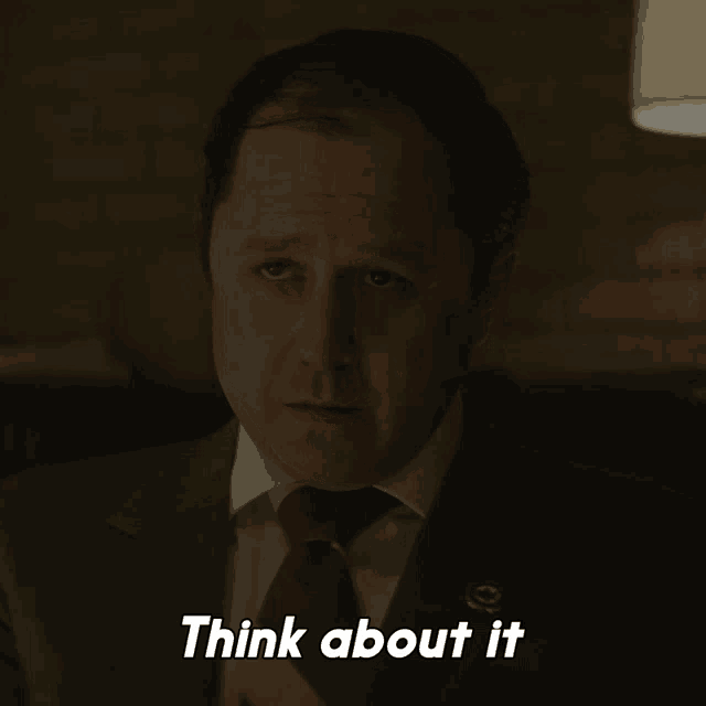 a man in a suit and tie has the words think about it below him
