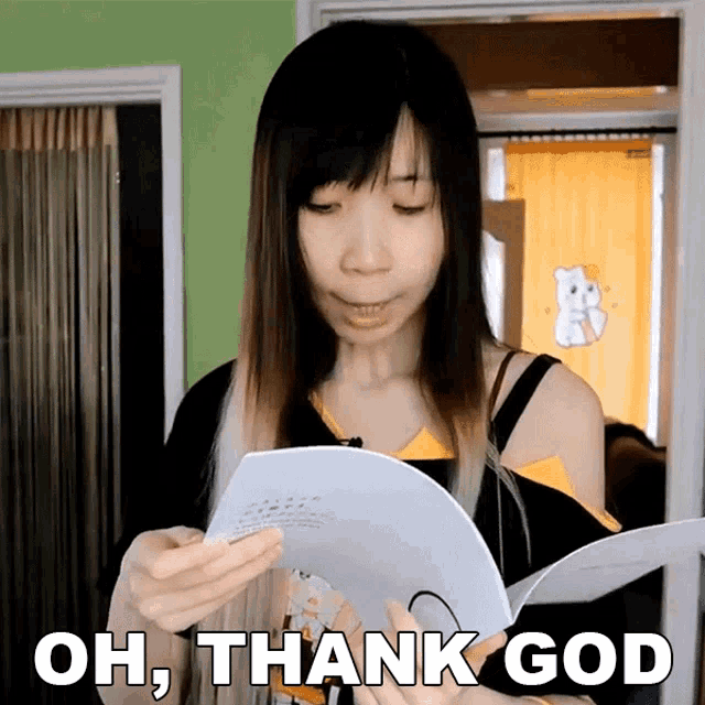 a woman holding a piece of paper with the words oh thank god on it