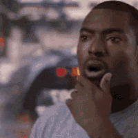 A man touches his cheek in a surprised “wow, really?” reaction.