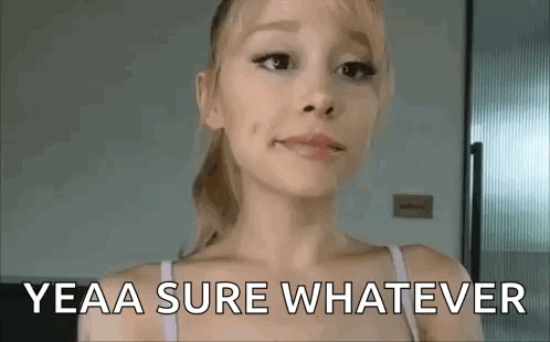 Ariana Grande gives a restrained side-eye in a room.