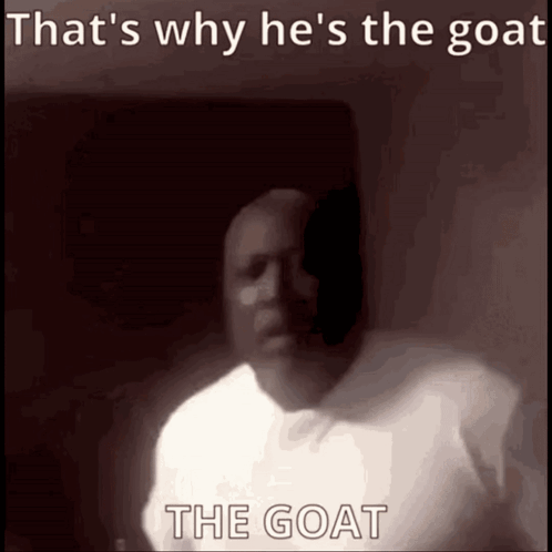 A man in a dim room is captioned “That's why he's the goat.”