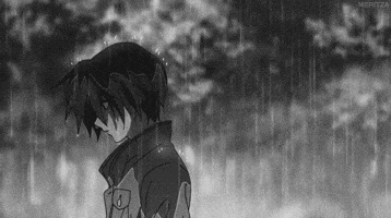 a black and white photo of a sad anime boy standing in the rain .