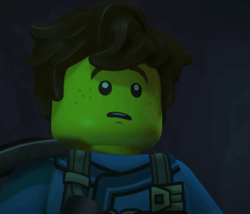 a lego figure with a green face and brown hair