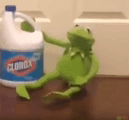 a kermit the frog is sitting next to a clorox bottle .