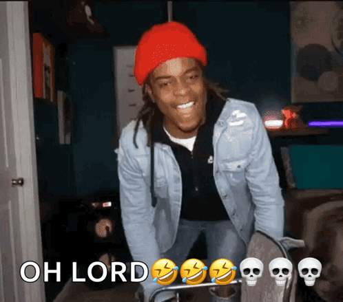 A smiling man in a red beanie leans forward as the caption says “OH LORD” with laughing and skull emojis.